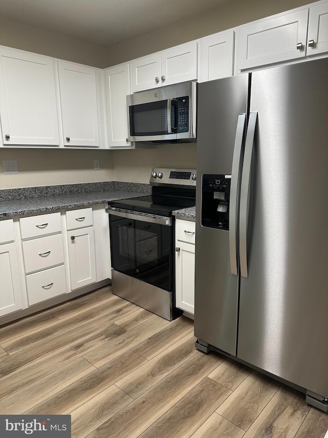 4321 Drake Ct, Waldorf, MD 20603 - kitchen with stainless steel appliances, white cabinets, and light wood-style floors