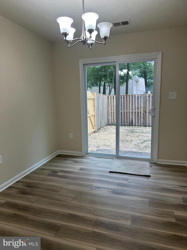 4321 Drake Ct, Waldorf, MD 20603 - unfurnished dining area featuring a chandelier, dark wood-type flooring, and baseboards