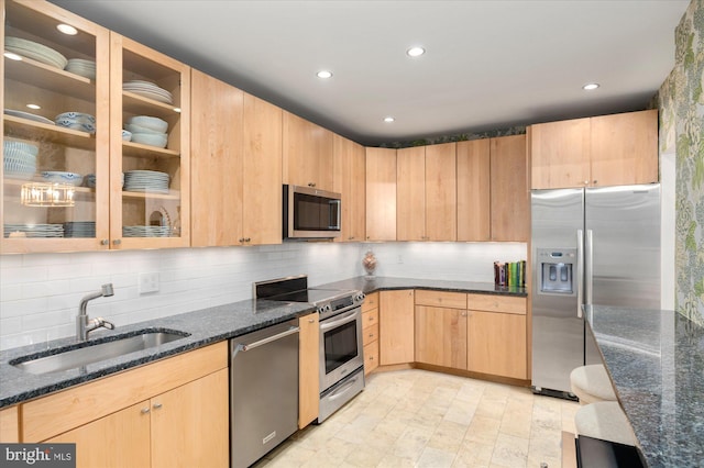 3277 Sutton Pl NW Unit C, Washington, DC 20016 - kitchen with appliances with stainless steel finishes, a sink, light brown cabinetry, dark stone countertops, and backsplash
