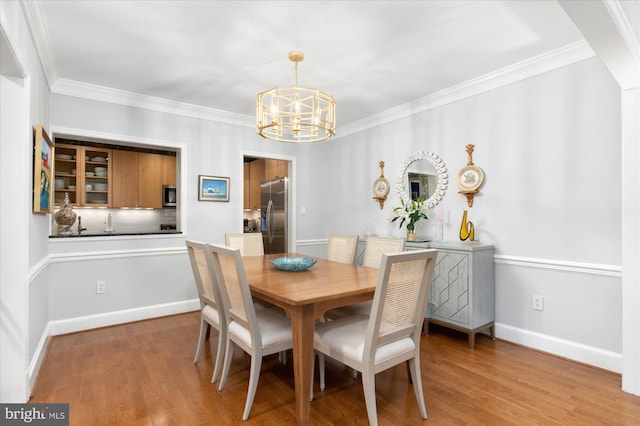 3277 Sutton Pl NW Unit C, Washington, DC 20016 - dining room featuring a chandelier, wood finished floors, ornamental molding, and baseboards