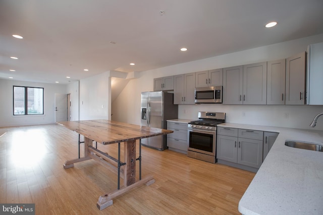 801 N 16th St Unit 1, Philadelphia, PA 19130 - kitchen featuring stainless steel appliances, a sink, gray cabinetry, light wood-style floors, and recessed lighting
