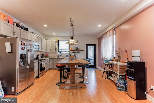 801 N 16th St Unit 1, Philadelphia, PA 19130 - kitchen featuring appliances with stainless steel finishes, light wood-type flooring, recessed lighting, hanging light fixtures, and light countertops