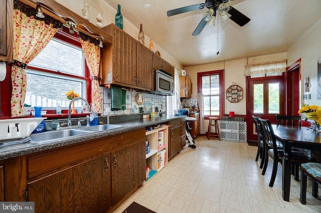 374 Fisher Dam Rd, Hamburg, PA 19526 - kitchen with a sink, stainless steel microwave, dark countertops, a ceiling fan, and open shelves