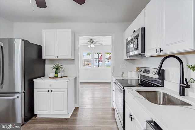 10 Taxi Way, Baltimore, MD 21220 - kitchen with stainless steel appliances, ceiling fan, wood finished floors, and white cabinetry