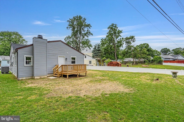 10 Taxi Way, Baltimore, MD 21220 - back of property with central AC unit, a wooden deck, and a chimney