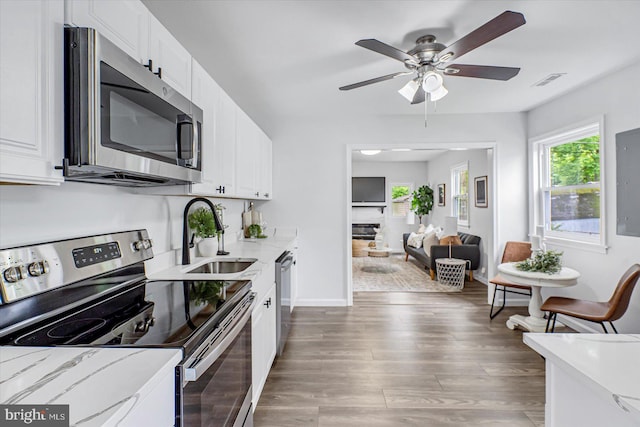 10 Taxi Way, Baltimore, MD 21220 - kitchen featuring stainless steel appliances, a sink, a ceiling fan, light wood-type flooring, and white cabinetry