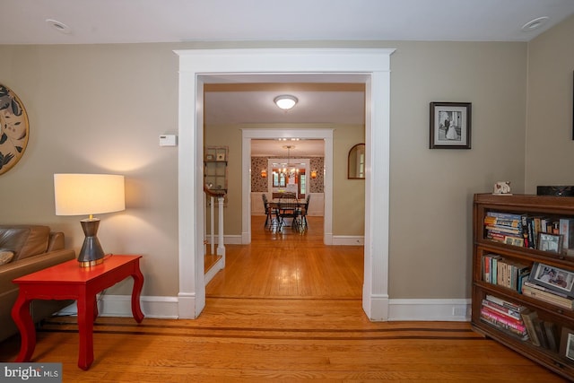 8317 High School Rd, Elkins Park, PA 19027 - hallway with light wood-style flooring and a chandelier