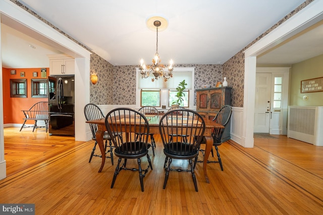 8317 High School Rd, Elkins Park, PA 19027 - dining space with wallpapered walls, wainscoting, a chandelier, and light wood finished floors