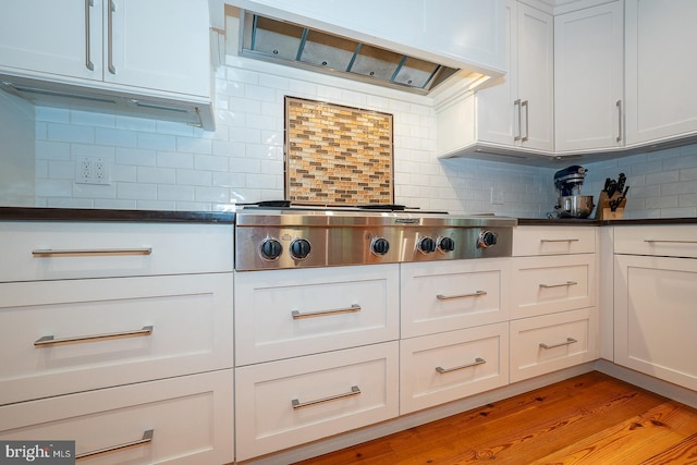 8317 High School Rd, Elkins Park, PA 19027 - kitchen with stainless steel gas cooktop, custom range hood, decorative backsplash, dark countertops, and white cabinets