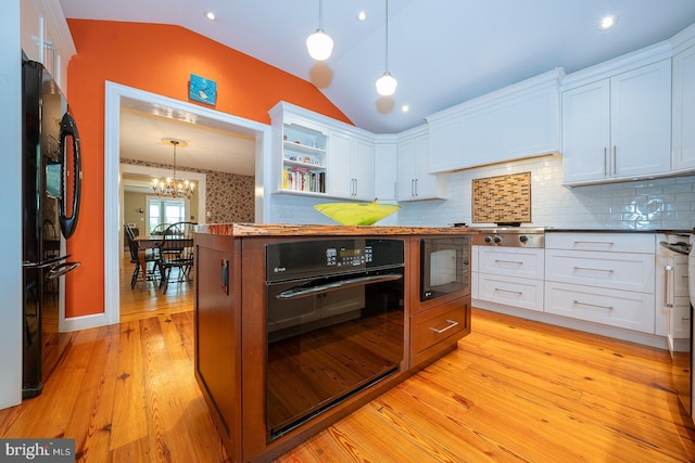 8317 High School Rd, Elkins Park, PA 19027 - kitchen with black appliances, lofted ceiling, open shelves, white cabinetry, and a chandelier