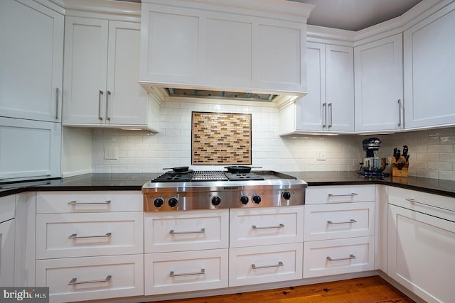8317 High School Rd, Elkins Park, PA 19027 - kitchen featuring stainless steel gas stovetop, premium range hood, white cabinetry, and tasteful backsplash