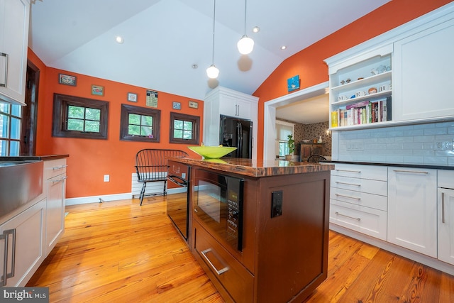 8317 High School Rd, Elkins Park, PA 19027 - kitchen with black appliances, lofted ceiling, dark countertops, white cabinetry, and open shelves