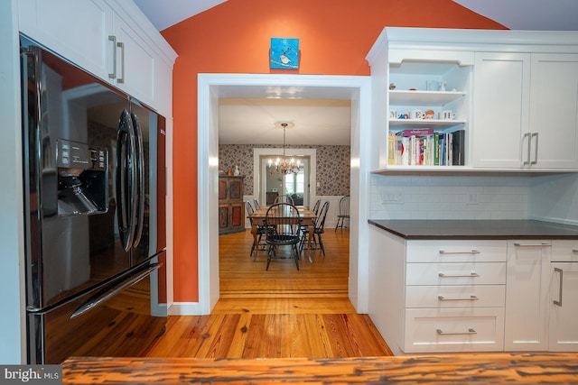 8317 High School Rd, Elkins Park, PA 19027 - kitchen featuring fridge with ice dispenser, light wood finished floors, dark countertops, vaulted ceiling, and white cabinets