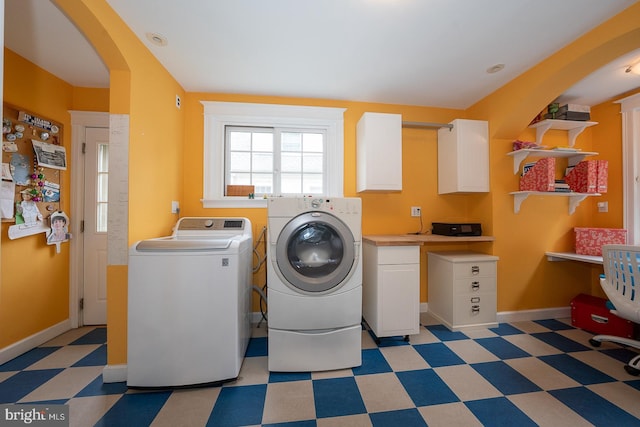 8317 High School Rd, Elkins Park, PA 19027 - washroom featuring light flooring, arched walkways, washer and clothes dryer, and cabinet space