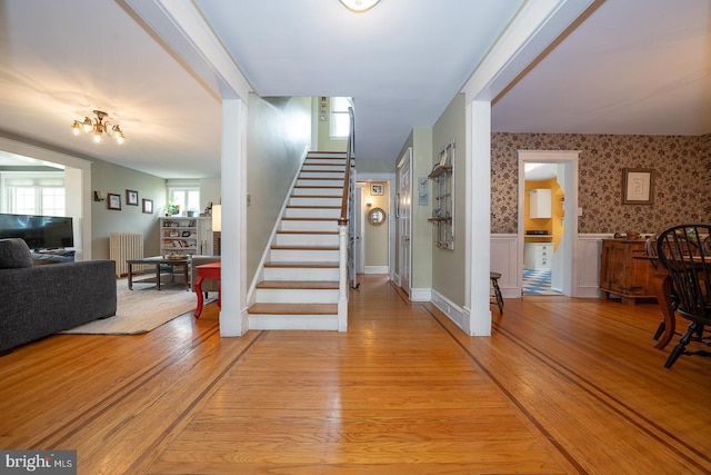8317 High School Rd, Elkins Park, PA 19027 - stairs featuring wallpapered walls, radiator, wood finished floors, and wainscoting