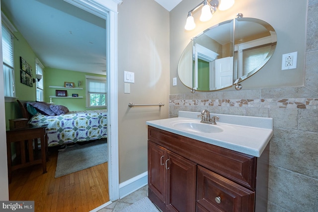 8317 High School Rd, Elkins Park, PA 19027 - ensuite bathroom with vanity, wood finished floors, and tile walls