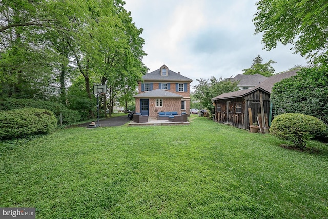 8317 High School Rd, Elkins Park, PA 19027 - rear view of property featuring an outdoor living space, brick siding, a yard, a storage unit, and a patio area
