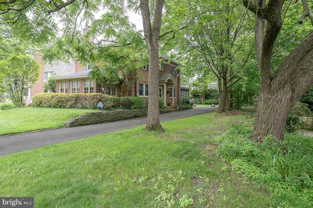 8317 High School Rd, Elkins Park, PA 19027 - view of front of home with brick siding, a front lawn, and driveway