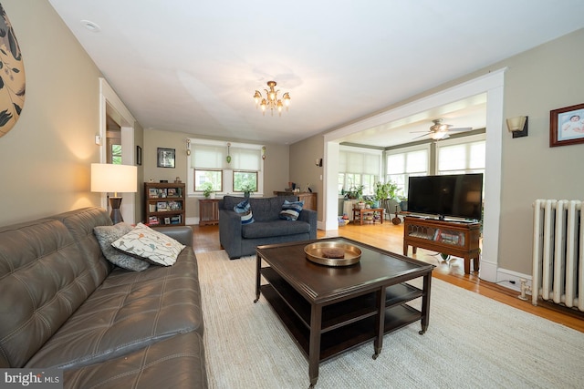 8317 High School Rd, Elkins Park, PA 19027 - living area featuring radiator heating unit, light wood-style flooring, and a chandelier