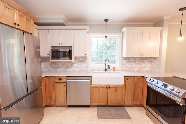204 W Irvin Ave W, Hagerstown, MD 21742 - kitchen featuring stainless steel appliances, ornamental molding, light countertops, and hanging light fixtures