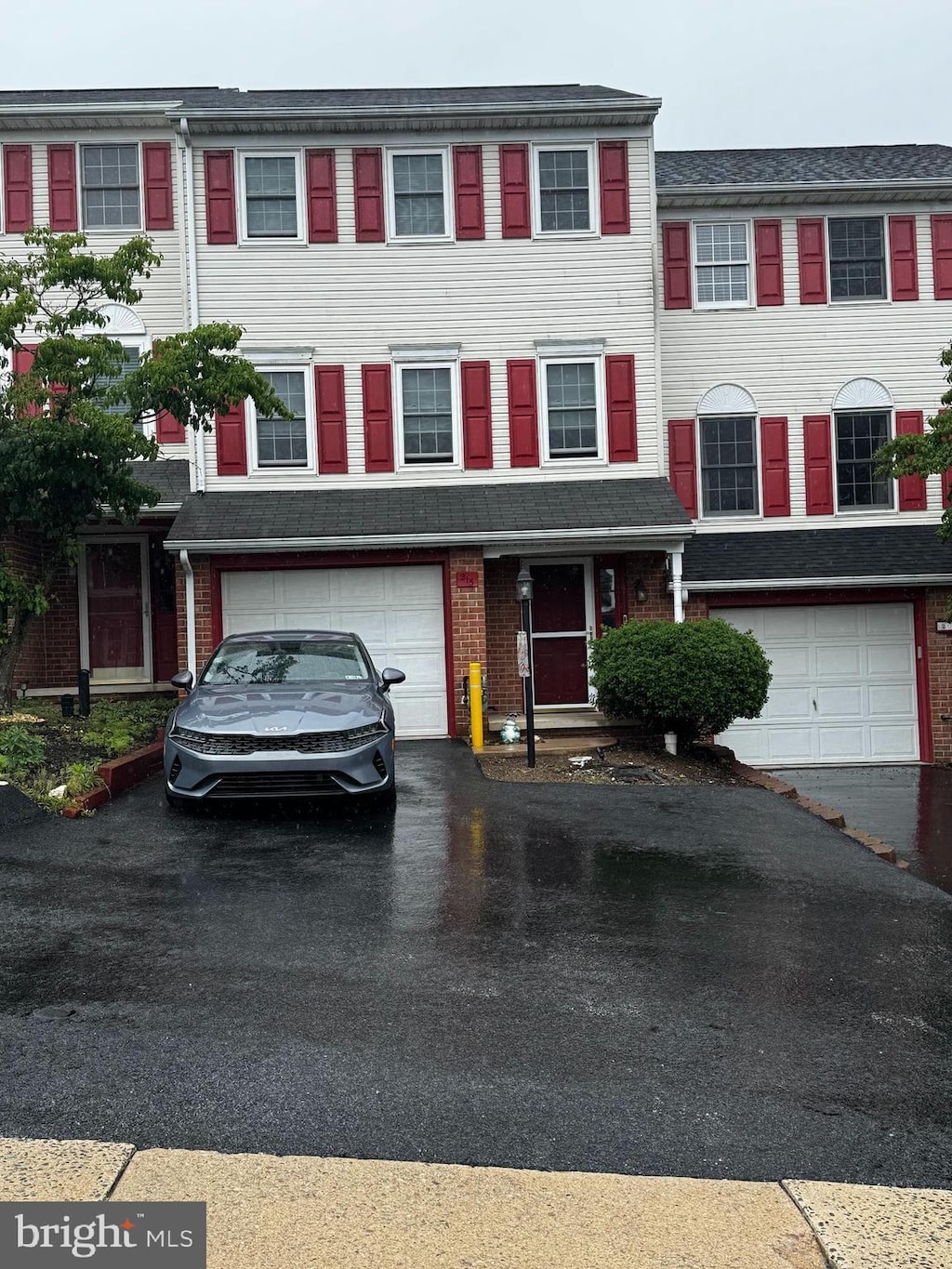 215 Robin Hill Cir, York, PA 17404 - multi unit property with an attached garage, driveway, and brick siding