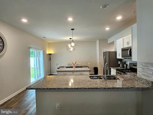529 Birchwood Dr, Salisbury, MD 21804 - kitchen with stainless steel appliances, stone countertops, a sink, backsplash, and dark wood-type flooring