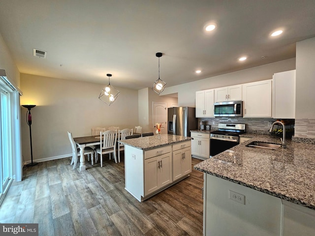 529 Birchwood Dr, Salisbury, MD 21804 - kitchen with appliances with stainless steel finishes, a sink, tasteful backsplash, dark stone counters, and white cabinets