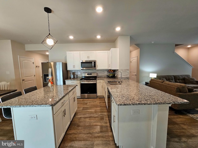 529 Birchwood Dr, Salisbury, MD 21804 - kitchen with stainless steel appliances, a sink, a kitchen breakfast bar, white cabinets, and light stone counters