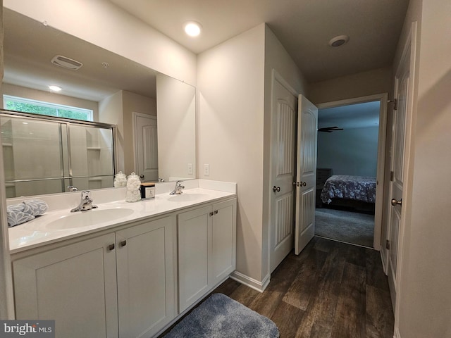 529 Birchwood Dr, Salisbury, MD 21804 - bathroom featuring wood finished floors, double vanity, ensuite bathroom, a stall shower, and baseboards