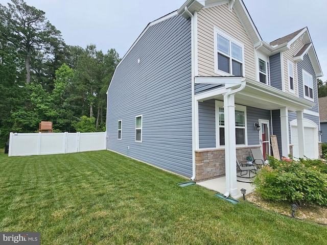 529 Birchwood Dr, Salisbury, MD 21804 - view of home's exterior with stone siding, a porch, and a garage