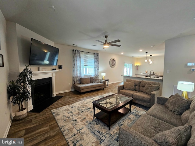 529 Birchwood Dr, Salisbury, MD 21804 - living room featuring a fireplace with flush hearth, a ceiling fan, wood finished floors, baseboards, and a chandelier
