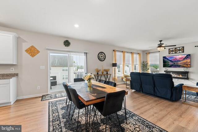 325 Hickory Ridge Cir, York, PA 17404 - dining space featuring light wood-type flooring, a glass covered fireplace, plenty of natural light, ceiling fan, and recessed lighting