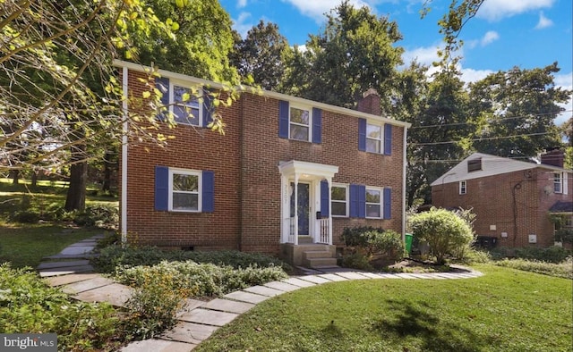7307 15th Ave, Takoma Park, MD 20912 - colonial house with a front lawn, a chimney, and brick siding