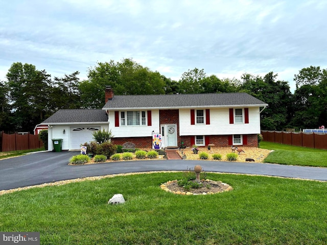 806 Edwards Dr, Fredericksburg, VA 22405 - split foyer home featuring driveway, a chimney, a garage, and brick siding