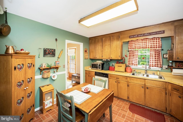 806 Edwards Dr, Fredericksburg, VA 22405 - kitchen with a sink, dishwashing machine, brick patterned floors, stainless steel microwave, and light countertops