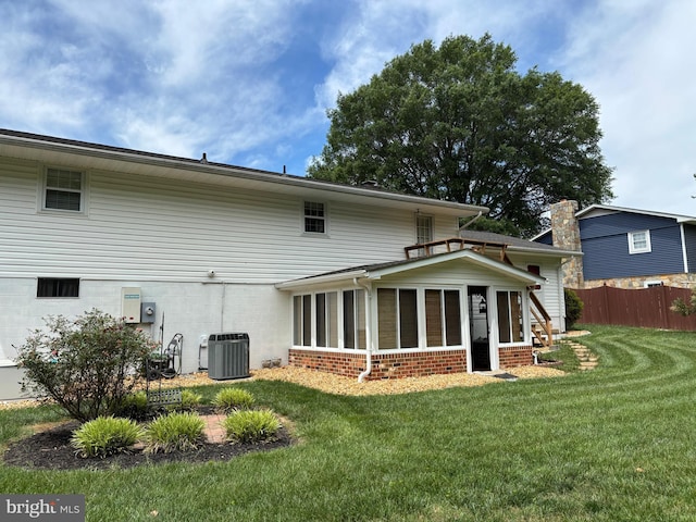 806 Edwards Dr, Fredericksburg, VA 22405 - back of house featuring central AC, a sunroom, and brick siding