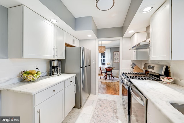 1615 Webster St NE, Washington, DC 20017 - kitchen with appliances with stainless steel finishes, white cabinets, recessed lighting, wall chimney range hood, and light stone countertops