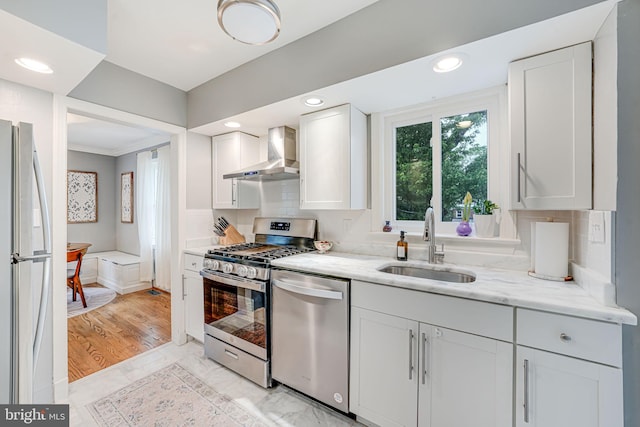 1615 Webster St NE, Washington, DC 20017 - kitchen with stainless steel appliances, wall chimney exhaust hood, a sink, light stone countertops, and white cabinets