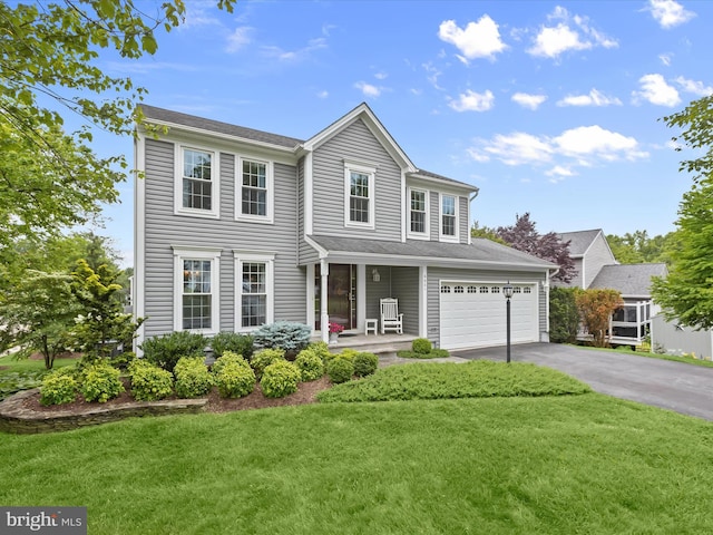 6601 Stipa Ct, Elkridge, MD 21075 - view of front of property featuring asphalt driveway, a front yard, an attached garage, and covered porch