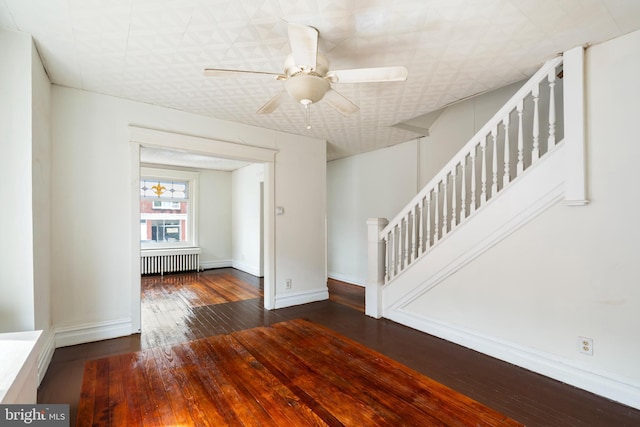 1926 W Broad St, Bethlehem, PA 18018 - empty room featuring radiator, stairs, hardwood / wood-style flooring, ceiling fan, and baseboards