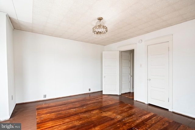1926 W Broad St, Bethlehem, PA 18018 - unfurnished room featuring dark wood-style flooring and a chandelier