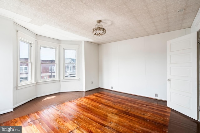 1926 W Broad St, Bethlehem, PA 18018 - spare room with wood-type flooring, a chandelier, and baseboards