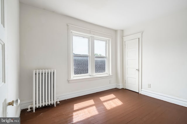 1926 W Broad St, Bethlehem, PA 18018 - empty room featuring radiator heating unit, dark wood-style floors, and baseboards