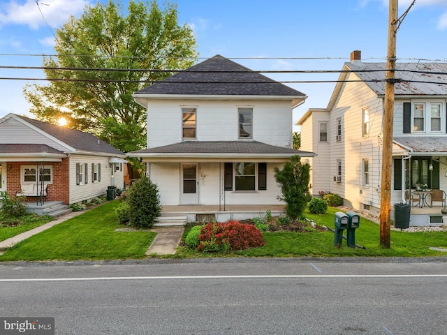 215 W Main St, Newmanstown, PA 17073 - view of front of property featuring covered porch, a front lawn, and roof with shingles