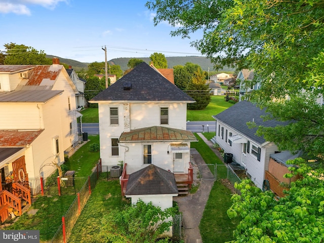 215 W Main St, Newmanstown, PA 17073 - rear view of house featuring cooling unit, a shingled roof, and a fire pit