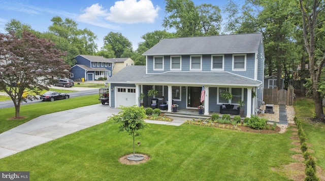 1367 Cedar Ave, Annapolis, MD 21403 - view of front of home with covered porch, an attached garage, concrete driveway, a front lawn, and a storage shed