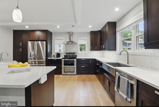 1367 Cedar Ave, Annapolis, MD 21403 - kitchen with stainless steel appliances, wall chimney range hood, a sink, tasteful backsplash, and light countertops