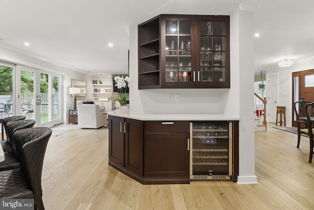 1367 Cedar Ave, Annapolis, MD 21403 - bar area with beverage cooler, light wood-style floors, ornamental molding, french doors, and recessed lighting