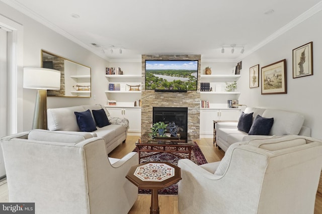 1367 Cedar Ave, Annapolis, MD 21403 - living room featuring rail lighting, wood finished floors, crown molding, and a stone fireplace