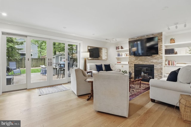 1367 Cedar Ave, Annapolis, MD 21403 - living room featuring ornamental molding, light wood finished floors, a fireplace, french doors, and track lighting